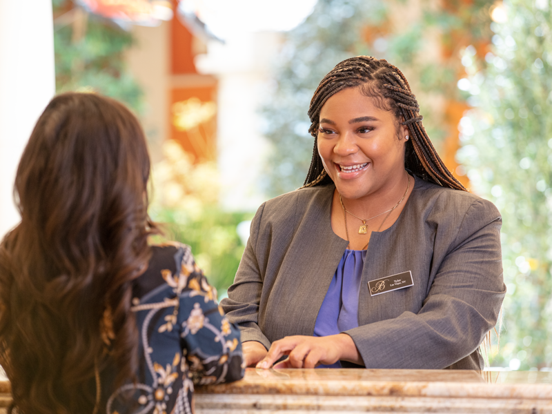 a person smiling at a person at a reception