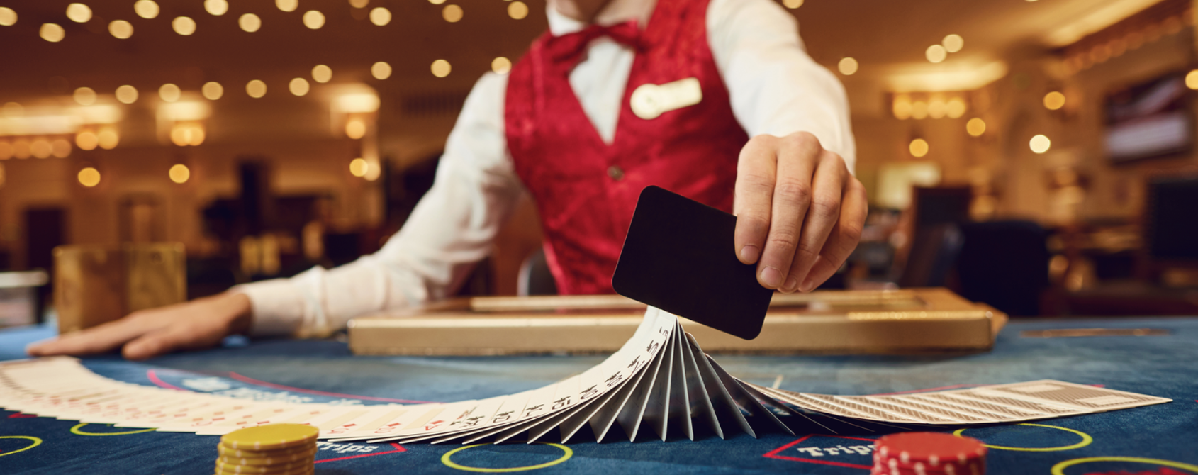 a person holding a card over a stack of cards