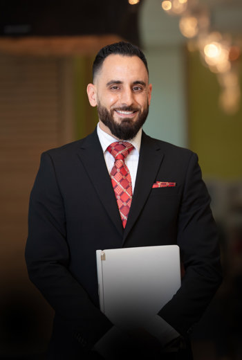 a person in a suit holding a laptop