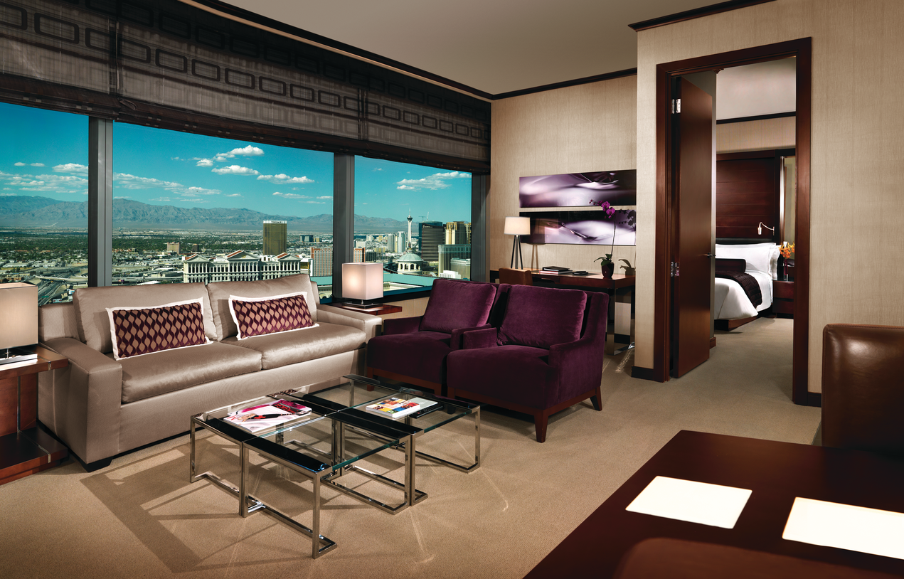 a living room with purple furniture and a glass coffee table