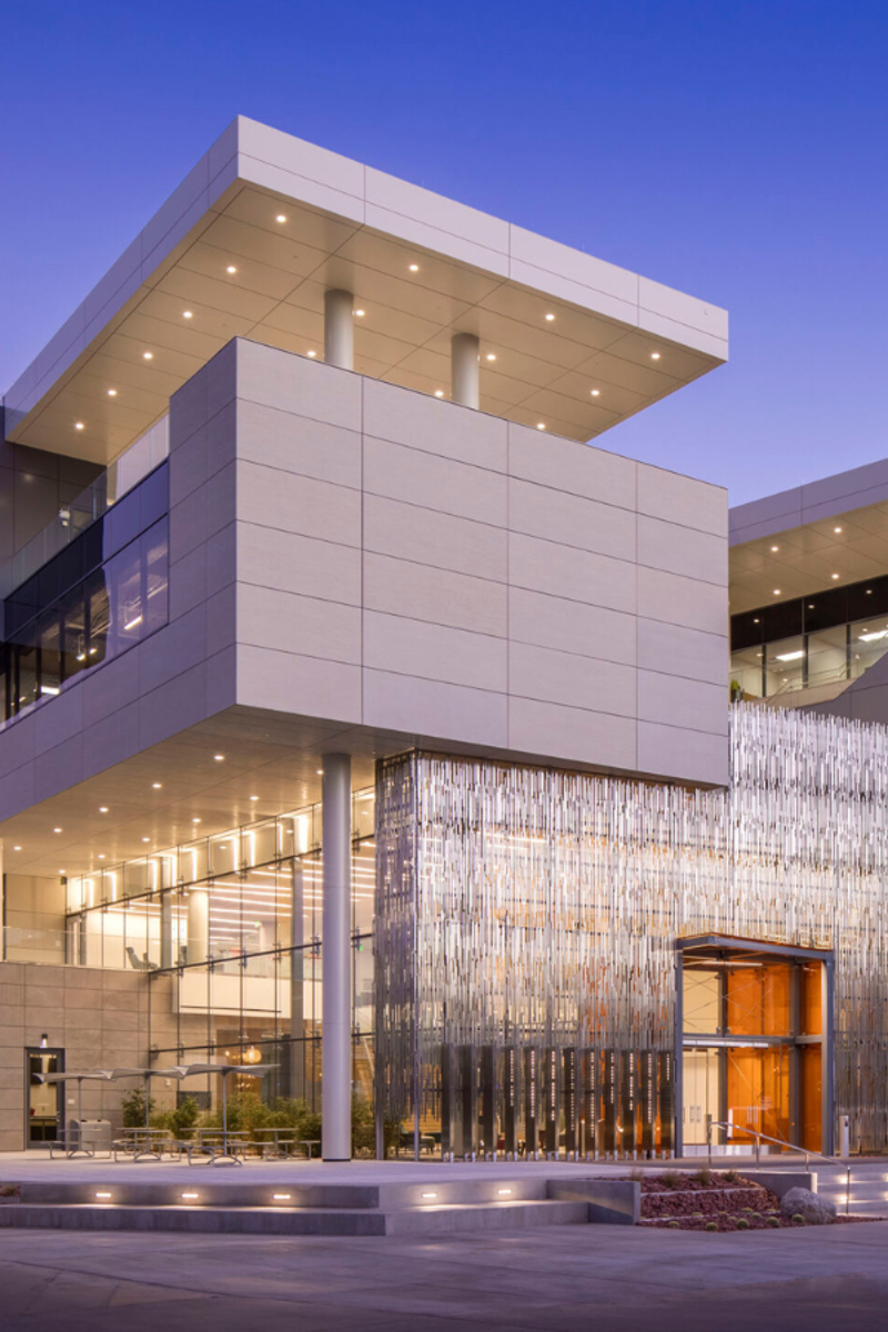 a building with a glass wall and a walkway