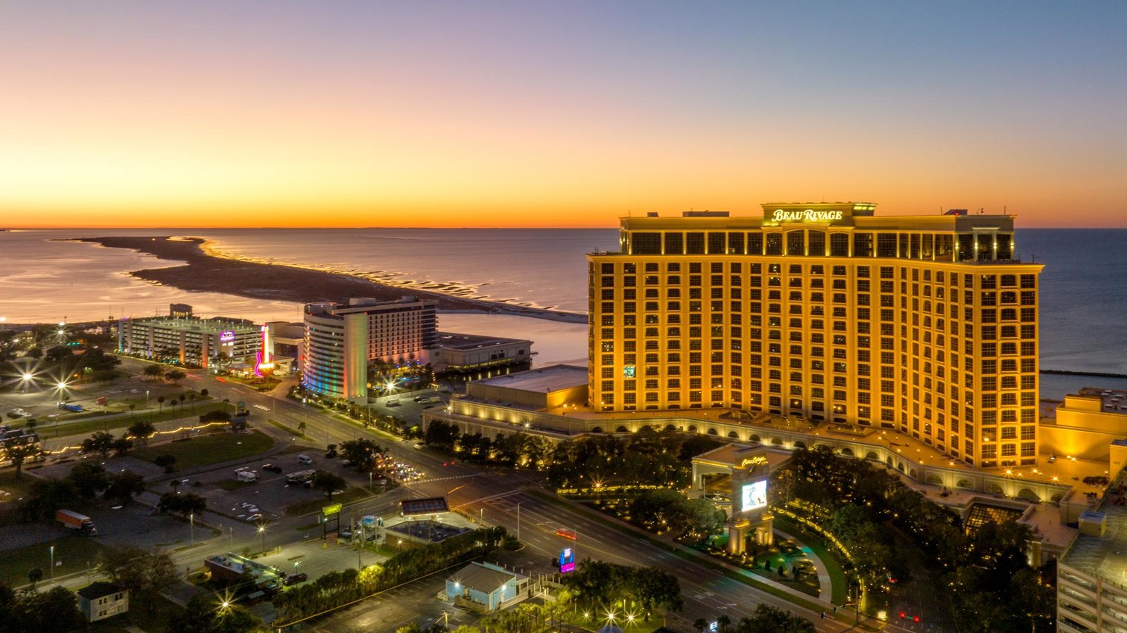 a large hotel next to a beach