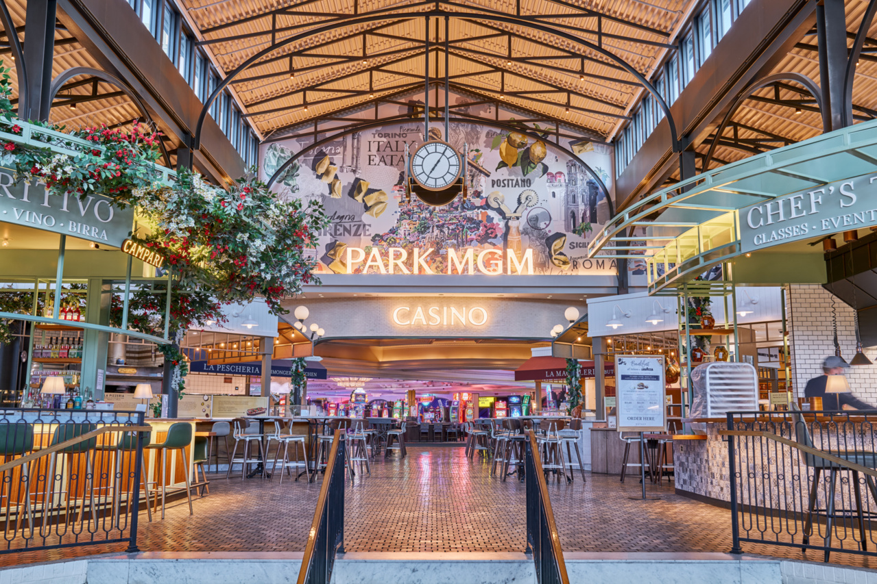 a large building with a clock and tables