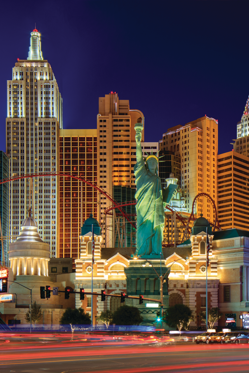 New York-New York Hotel and Casino with a statue and a roller coaster