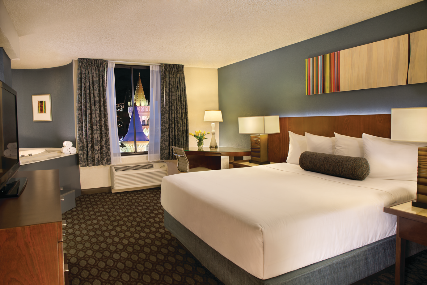 a hotel room with a bed and a window