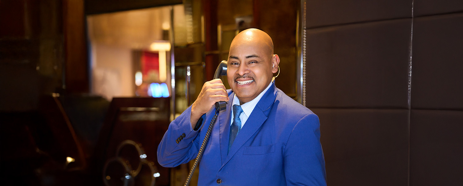 a person in a blue suit holding a phone