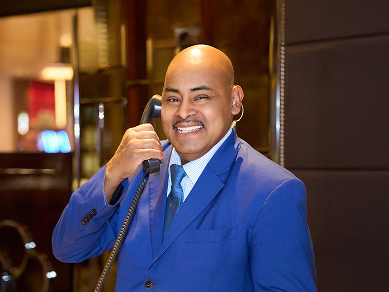 a person in a blue suit holding a phone