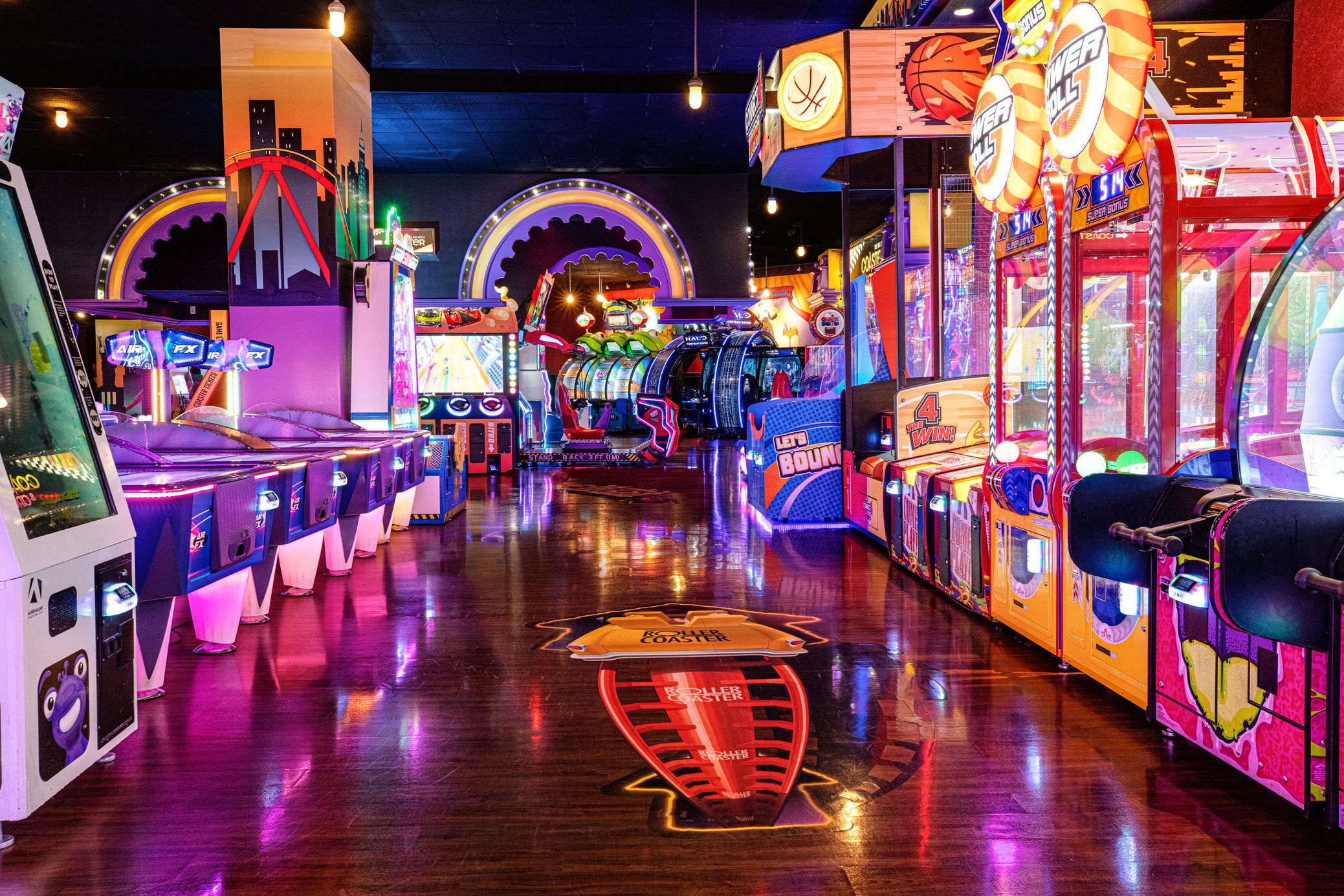 a arcade game room with arcade machines and lights