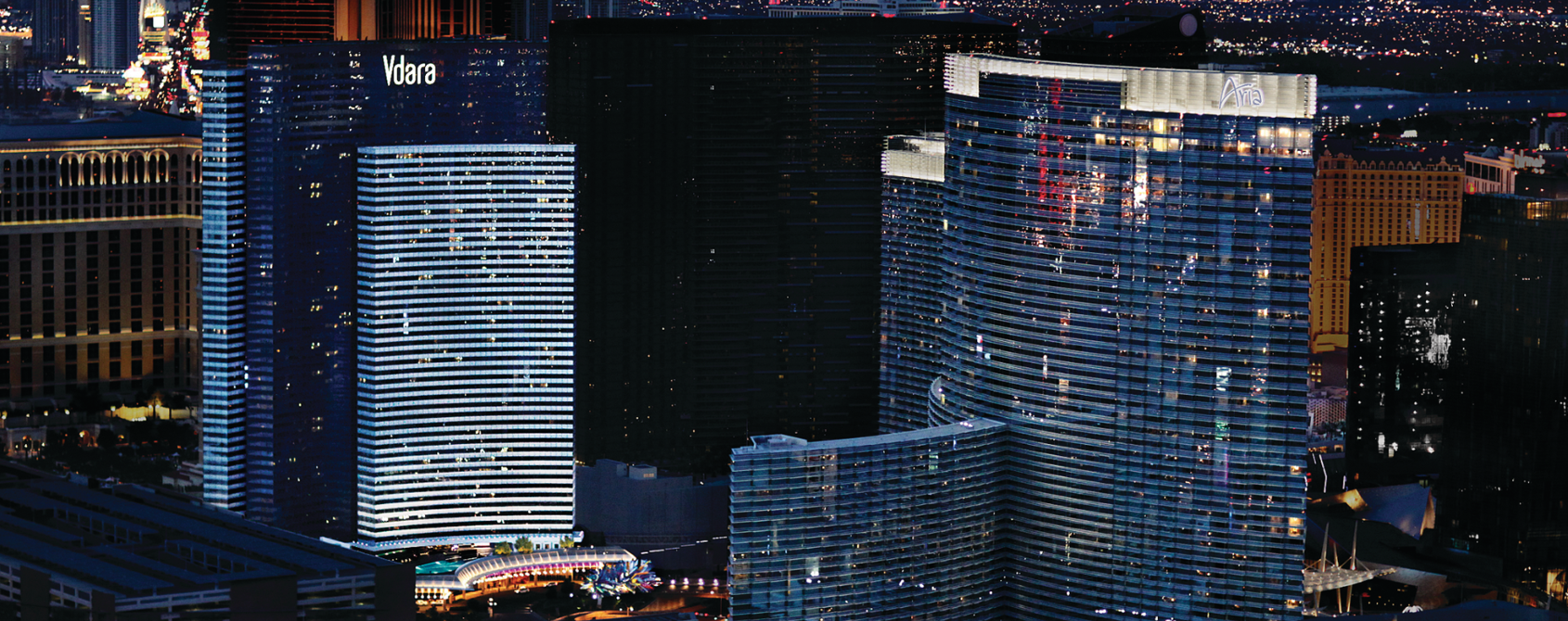 a group of tall buildings at night