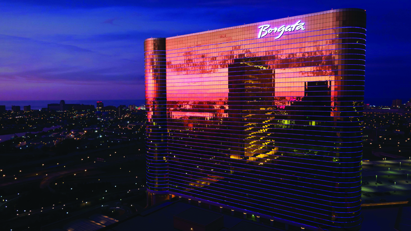 a building with lights reflecting the city