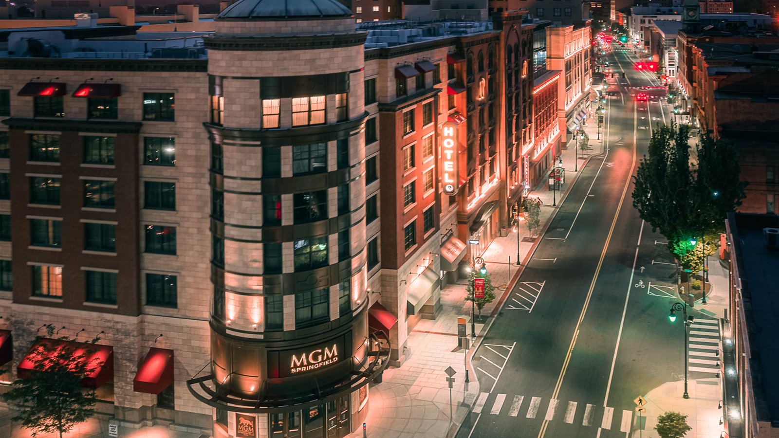a city street with buildings and lights