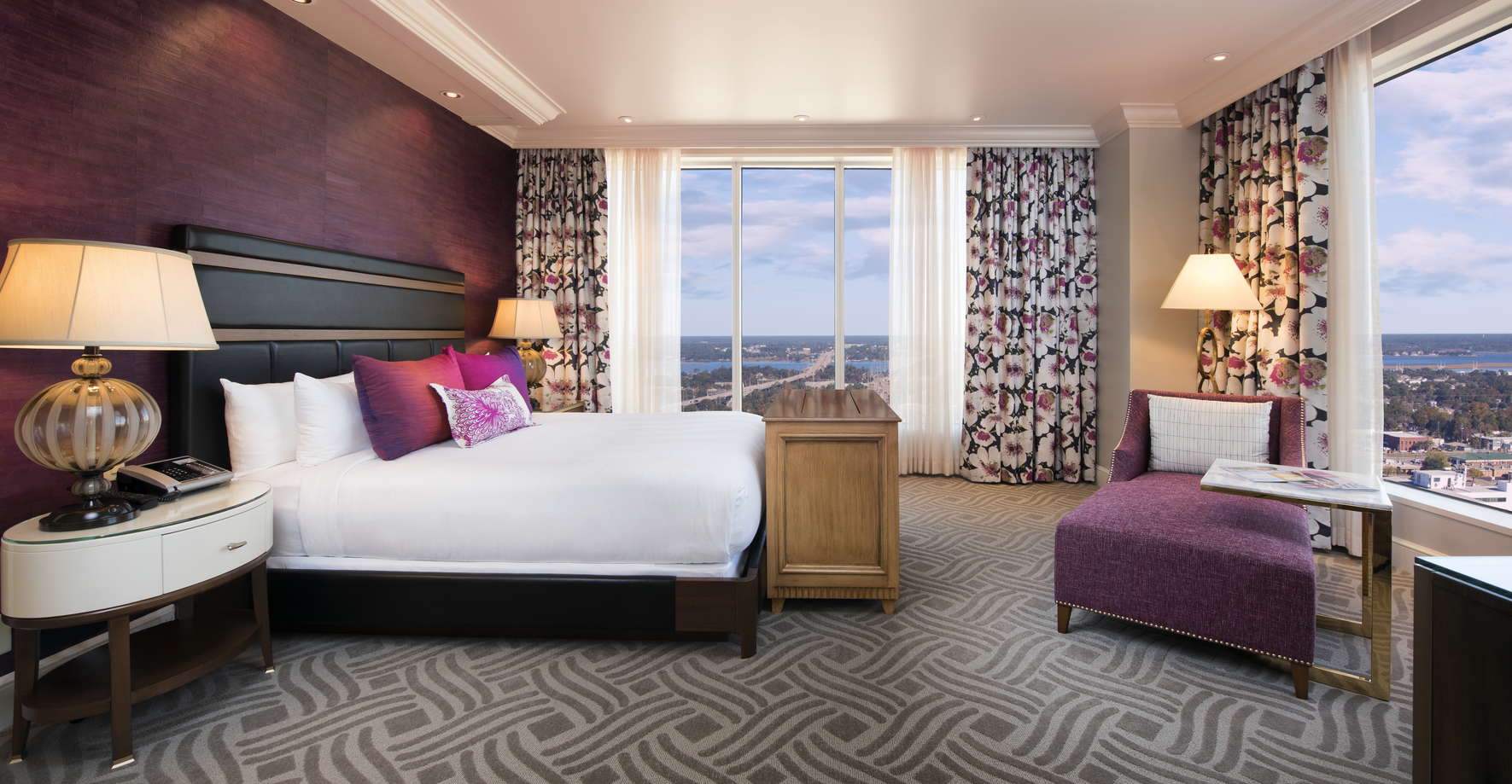 a bedroom with purple and pink curtains