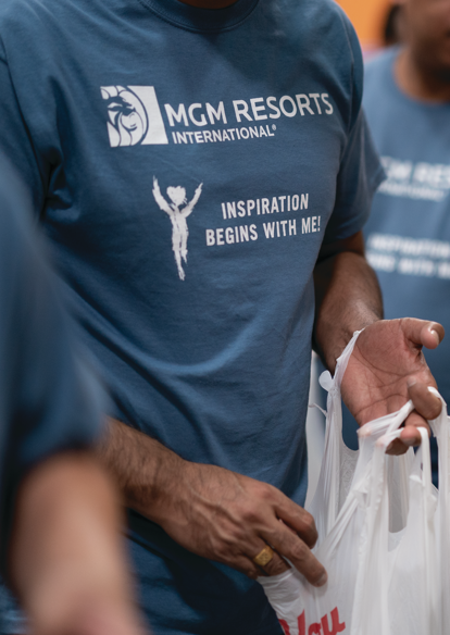 a group of people holding plastic bags