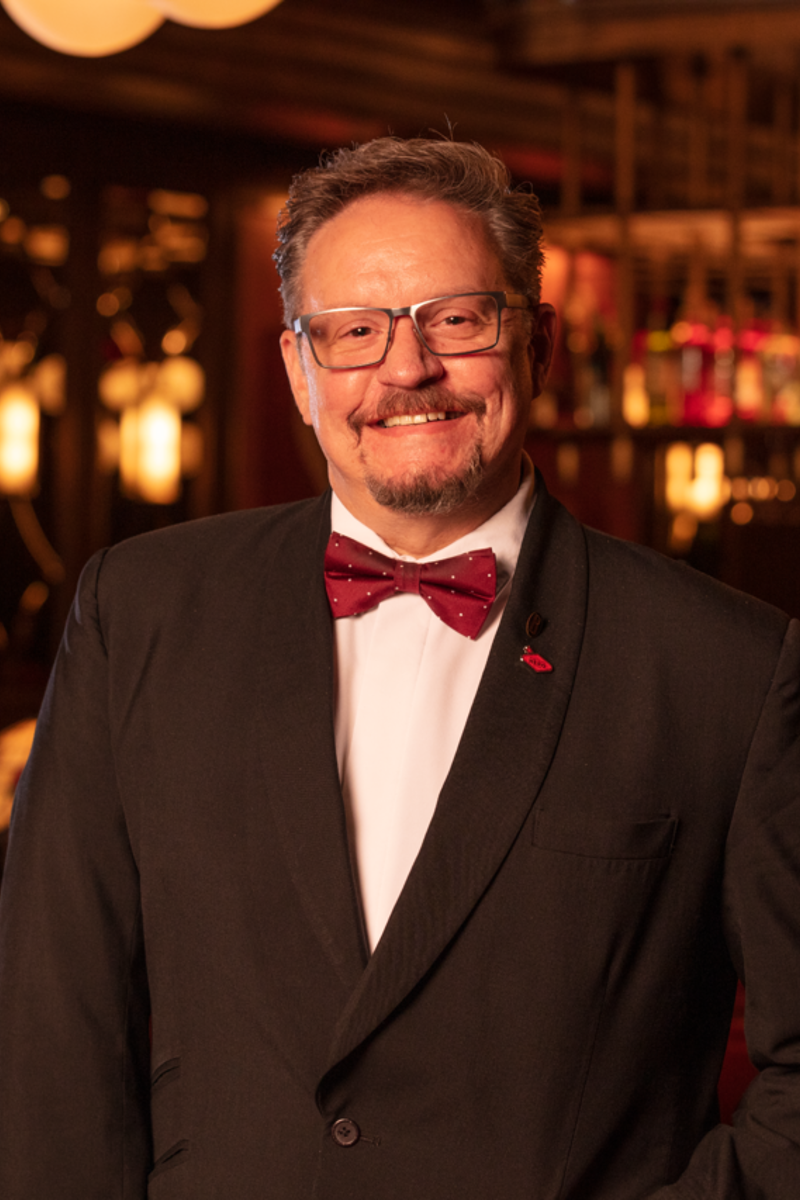 a person in a suit and bow tie