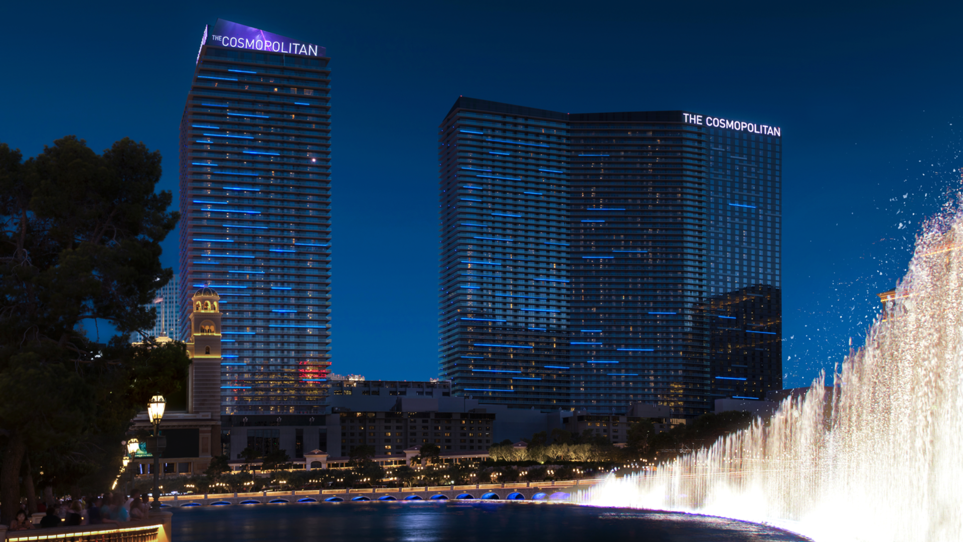 a water fountain with a fountain in front of a city skyline
