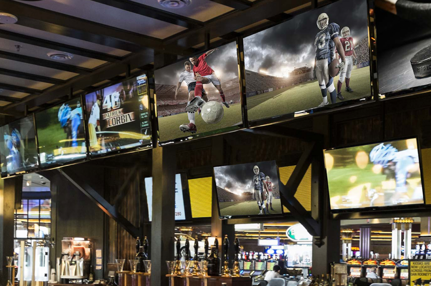 a wall with several screens on it