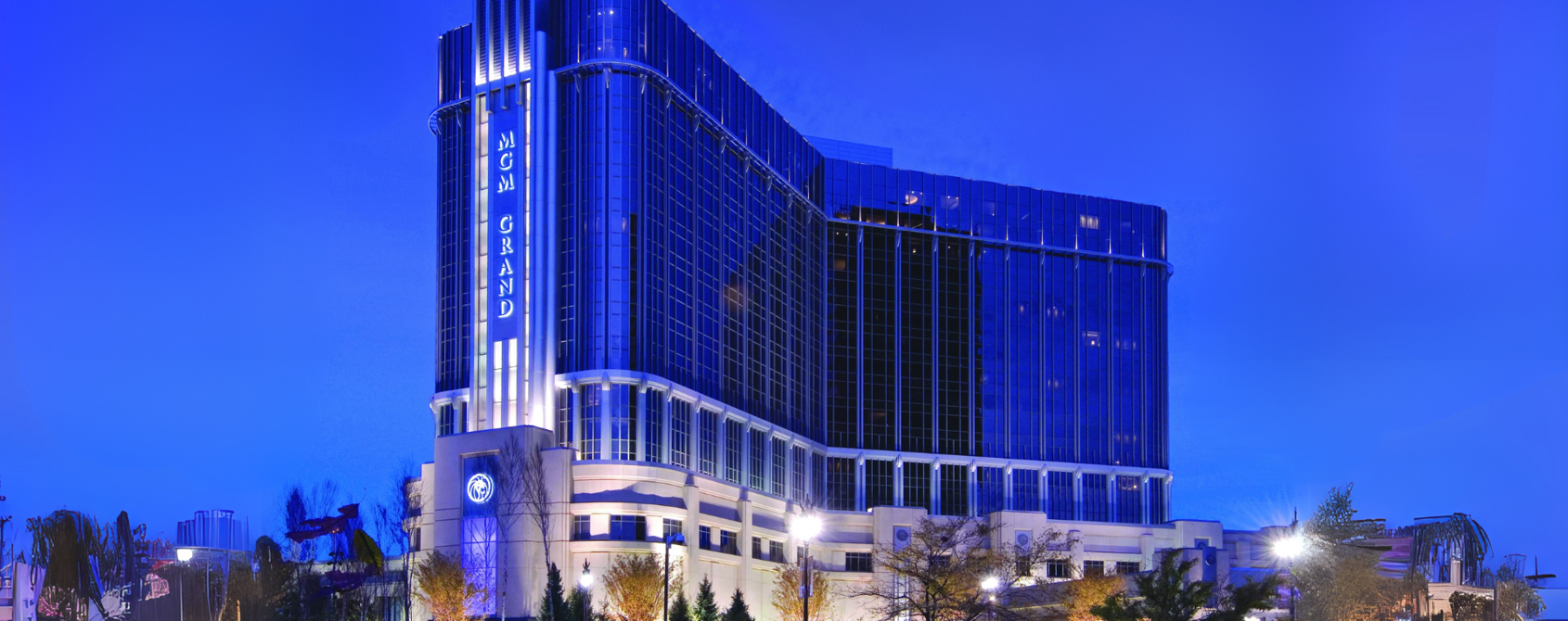 a large building with a blue sky with MGM Grand Detroit in the background
