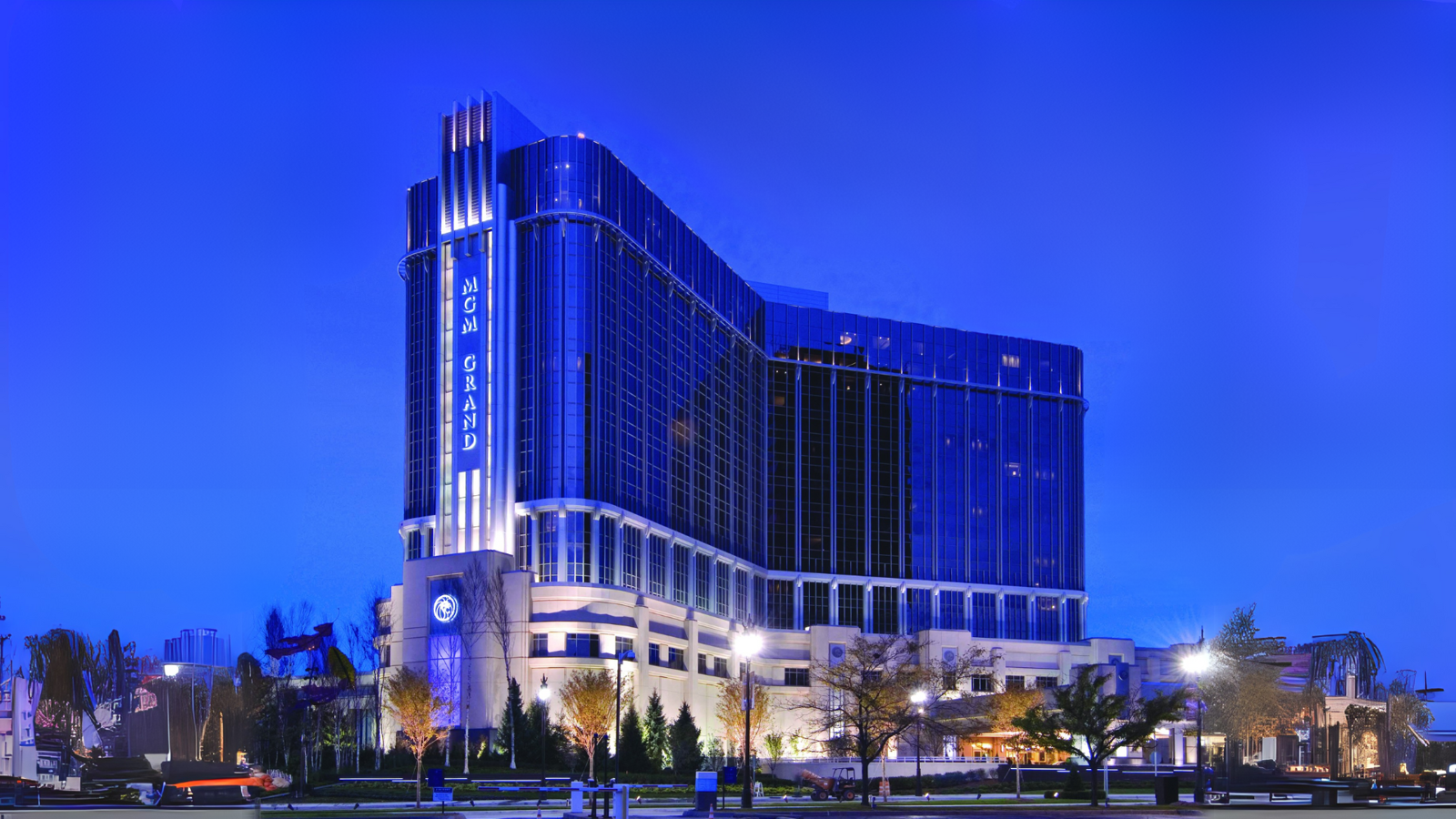 a large building with a blue sky with MGM Grand Detroit in the background