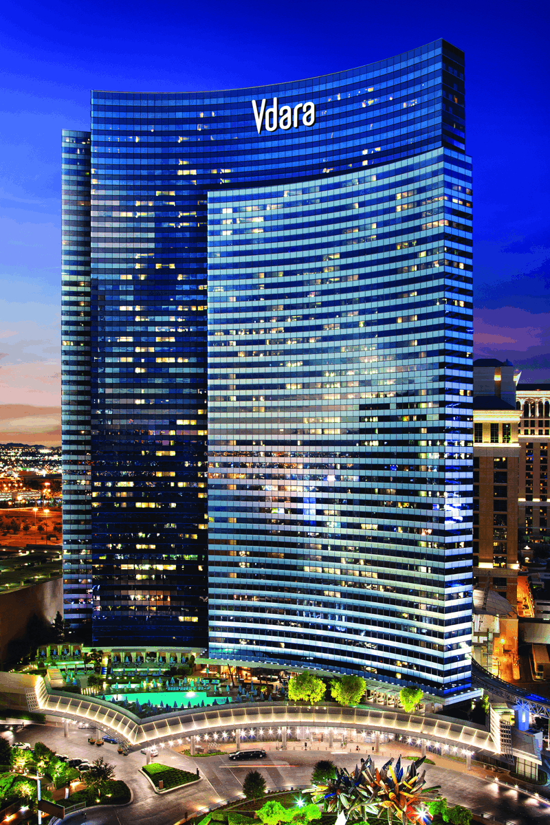 a city landscape with a large building and a fountain