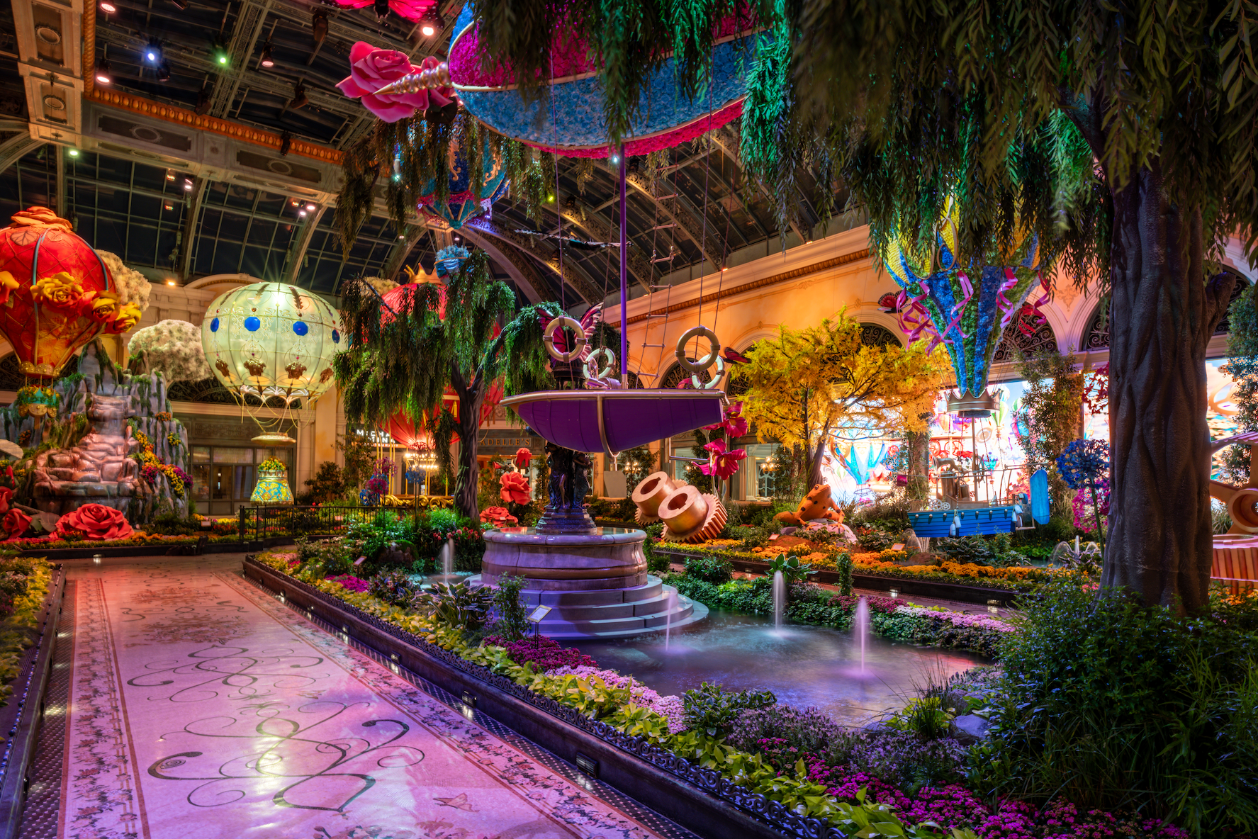 a indoor garden with a fountain and flowers
