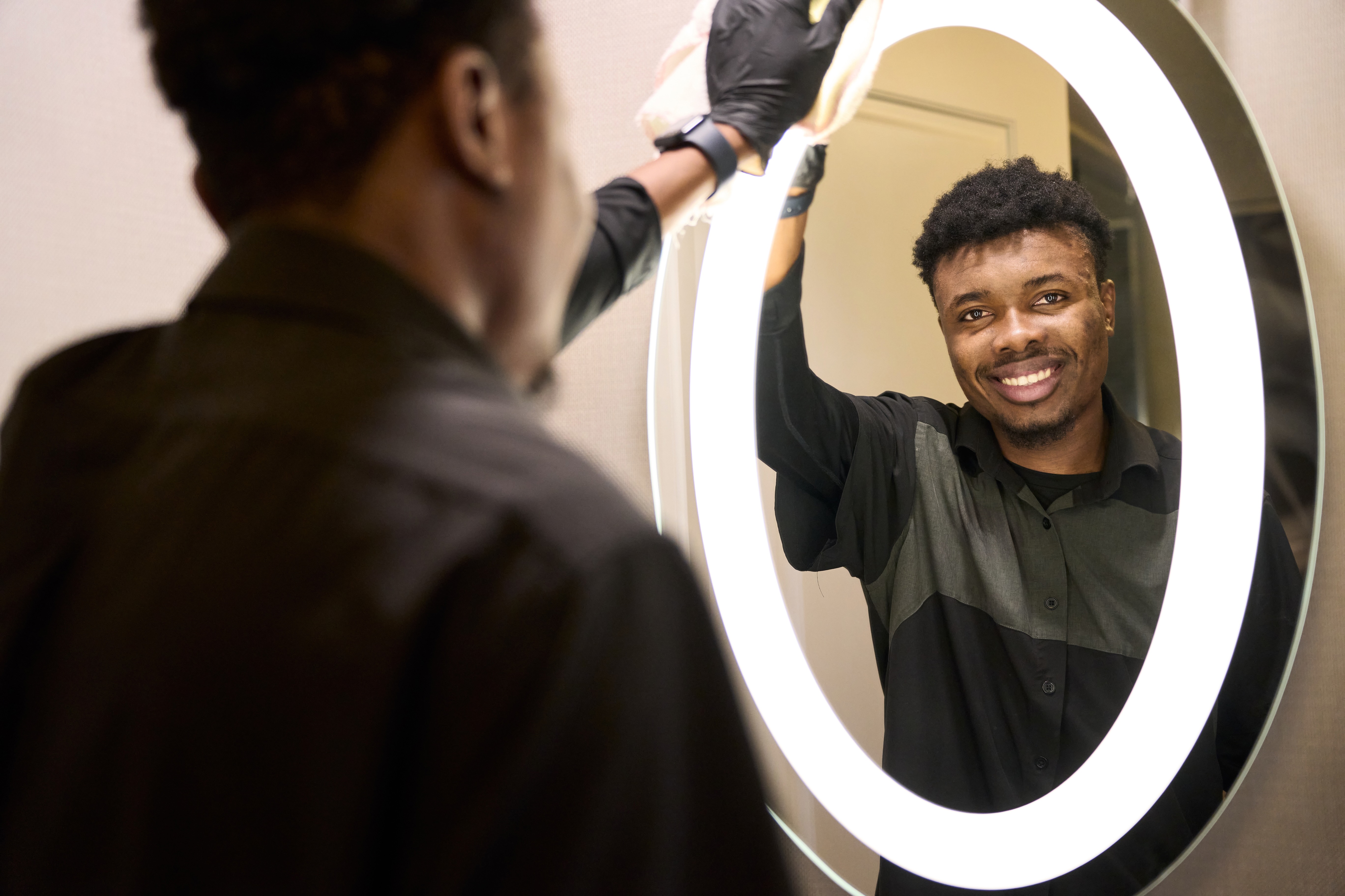 a person cleaning a mirror