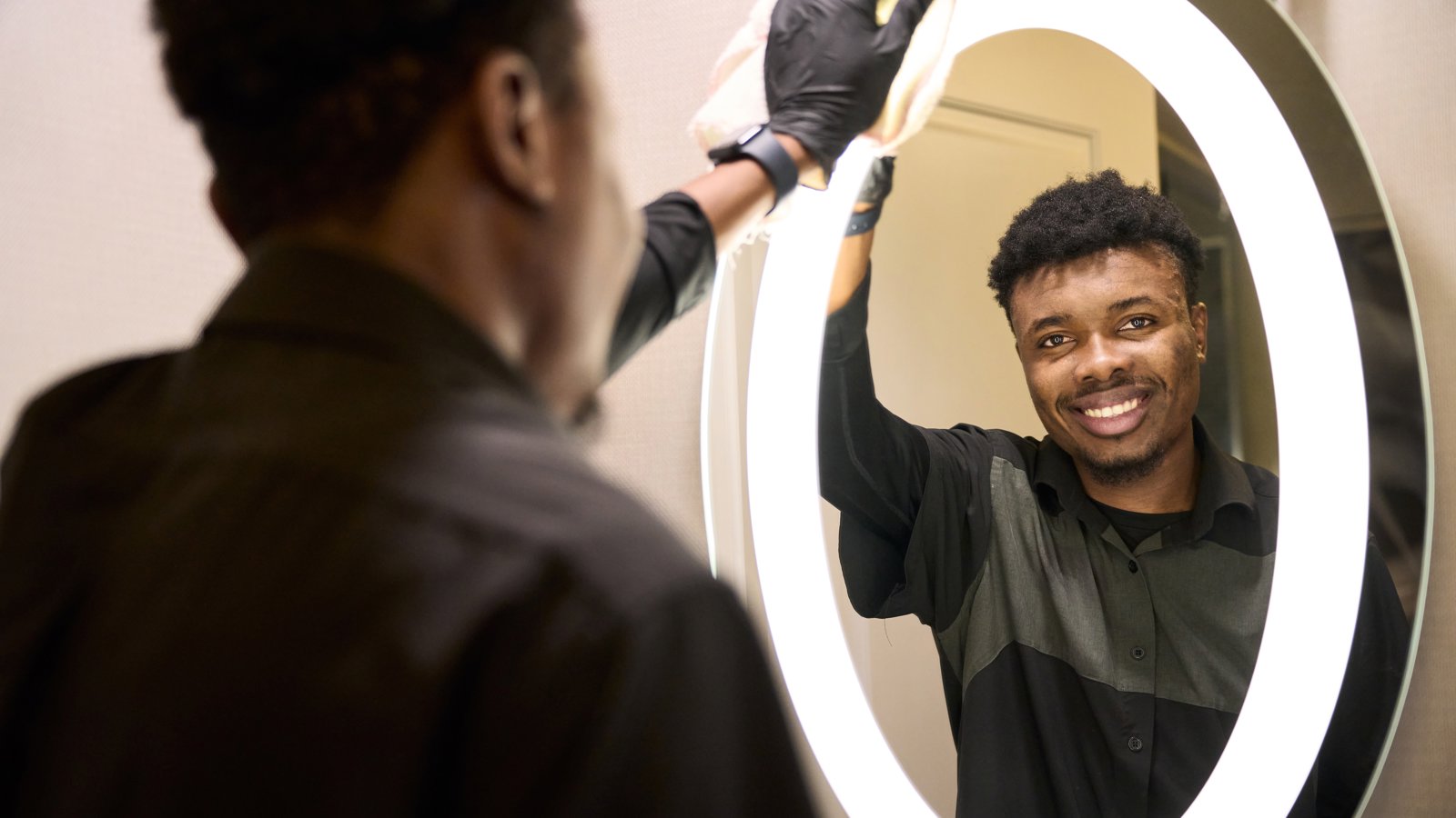 a person cleaning a mirror