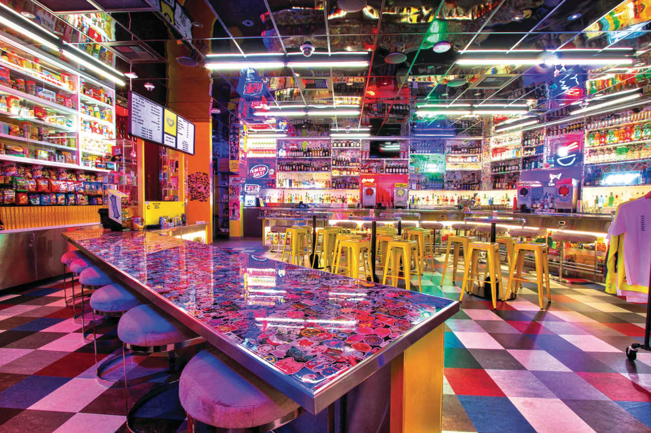 a bar with a colorful bar and shelves of liquor