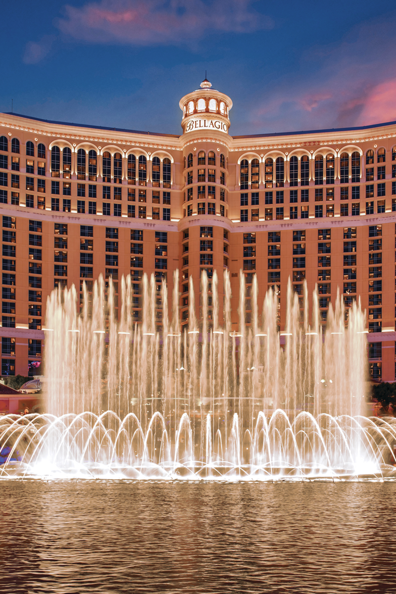a water fountain in front of a large building with Bellagio in the background