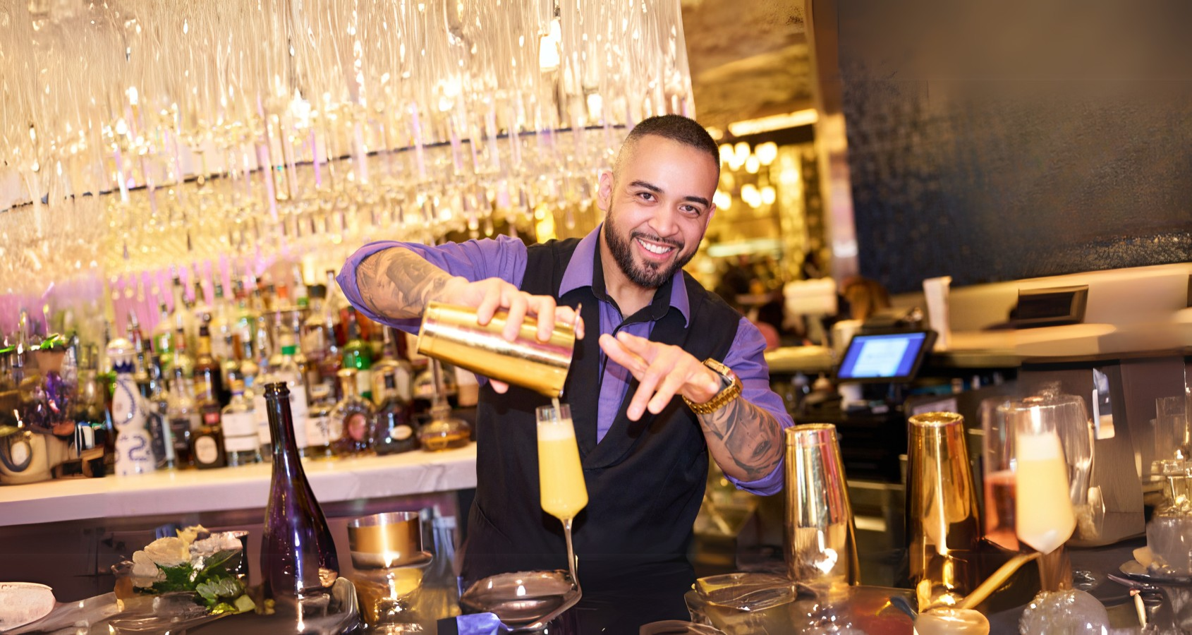 a person pouring a drink into a glass