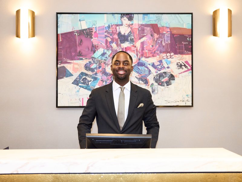 a person standing behind a desk