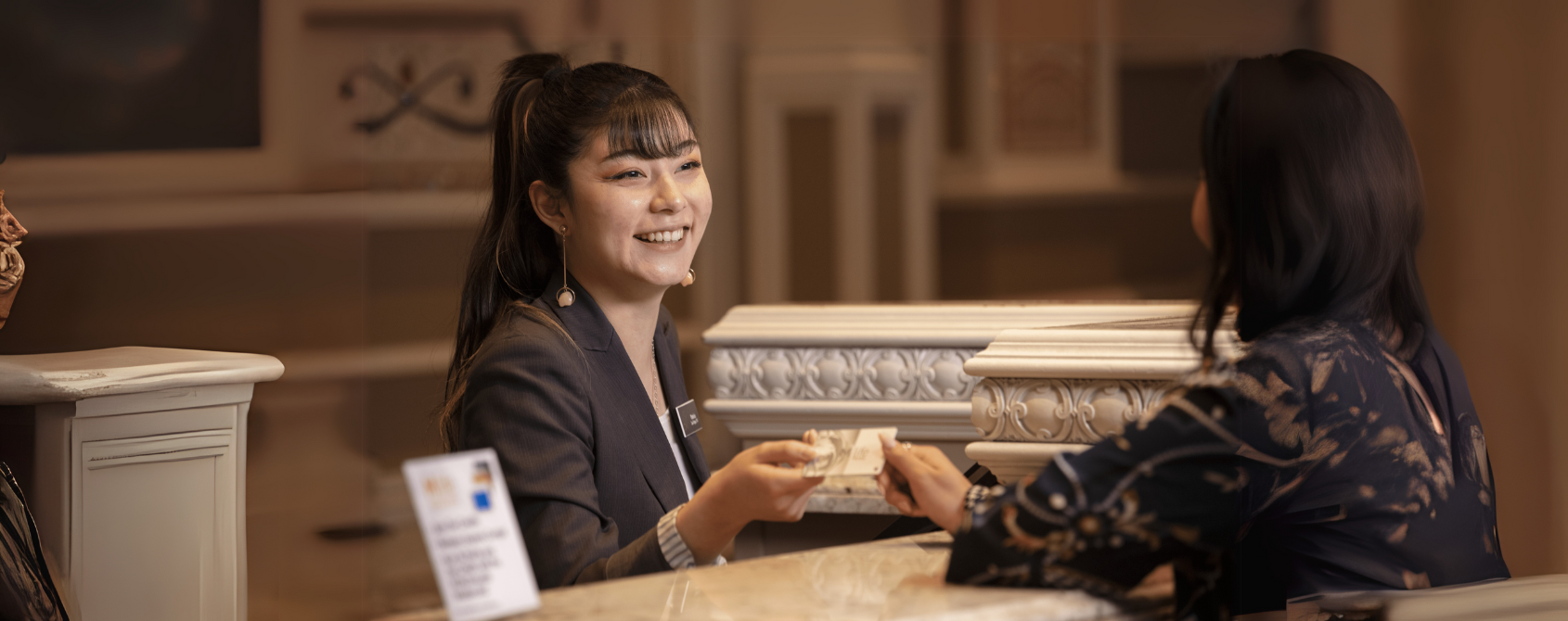 a person smiling at a hotel reception
