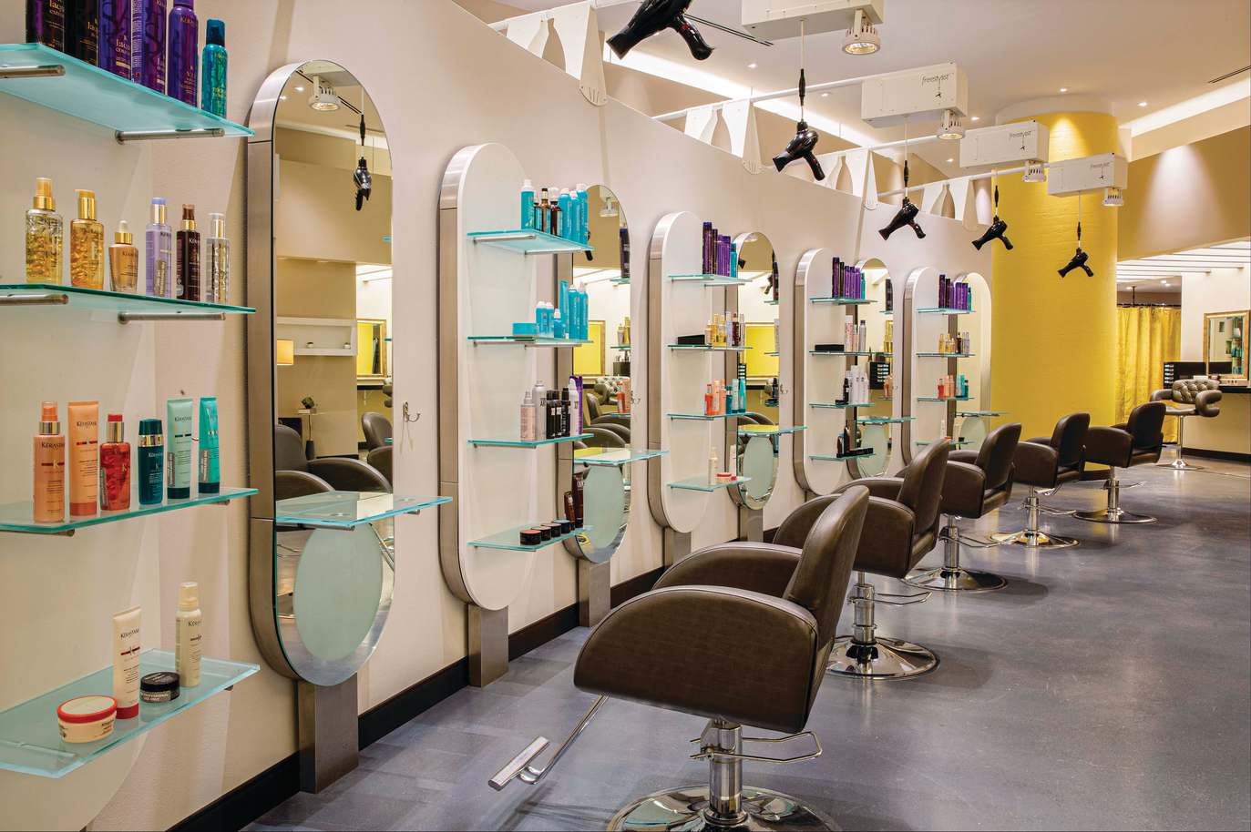 a hair salon with chairs and shelves