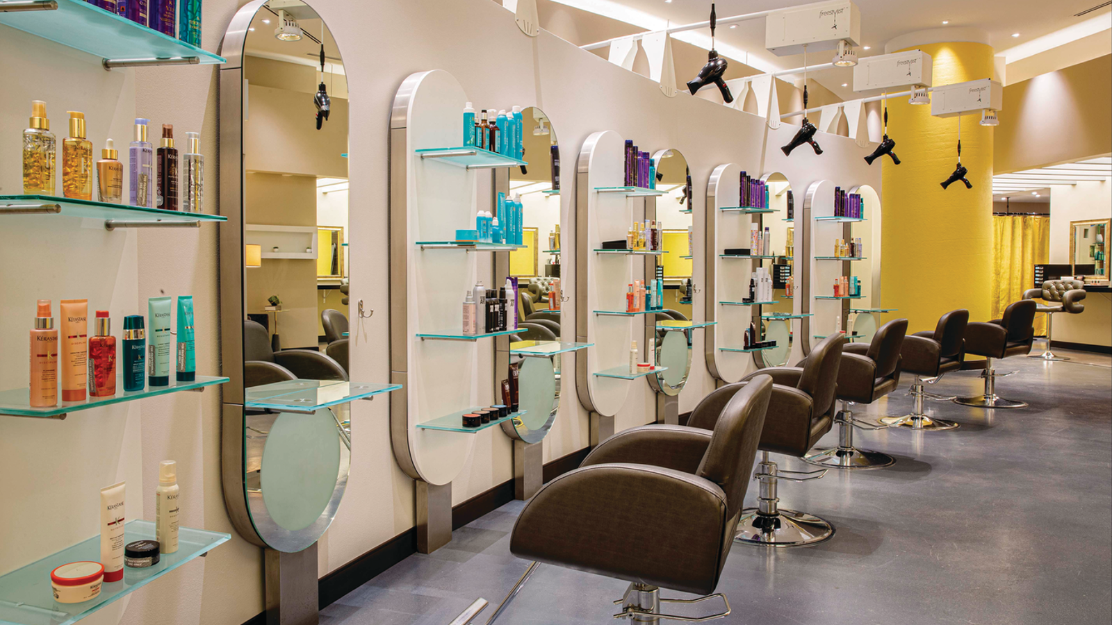 a hair salon with chairs and shelves