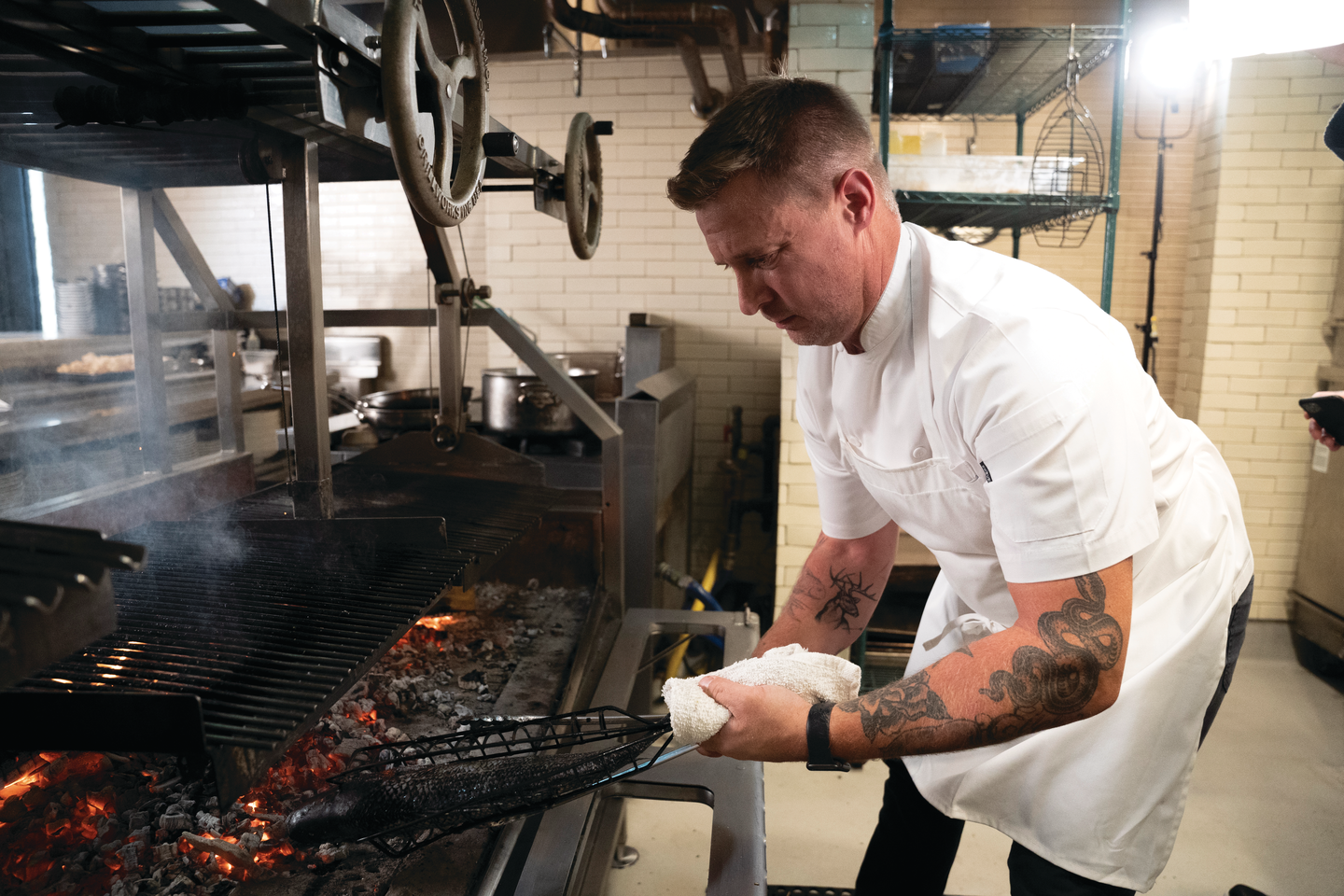 a person in a chef's uniform cooking food