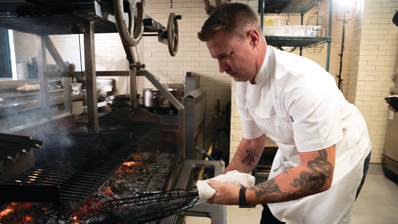 a person in a chef's uniform cooking food