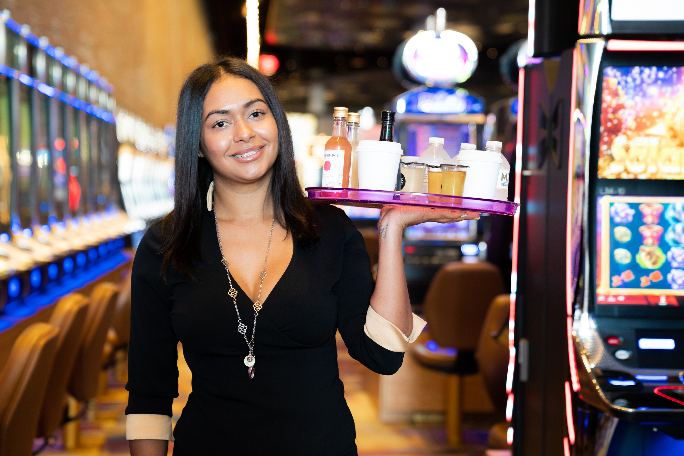 a person holding a tray of drinks