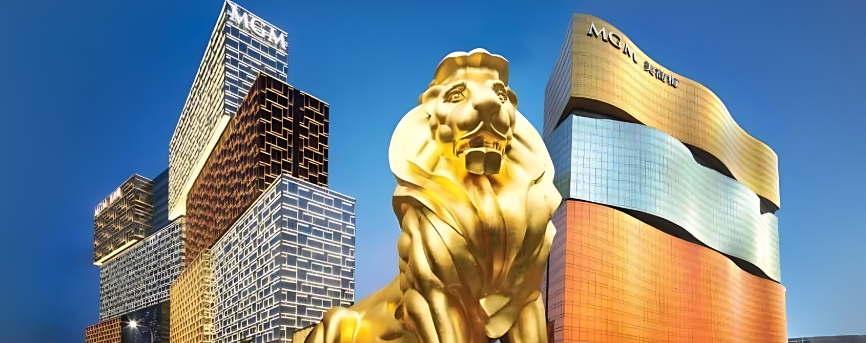 a golden lion statue in front of a city