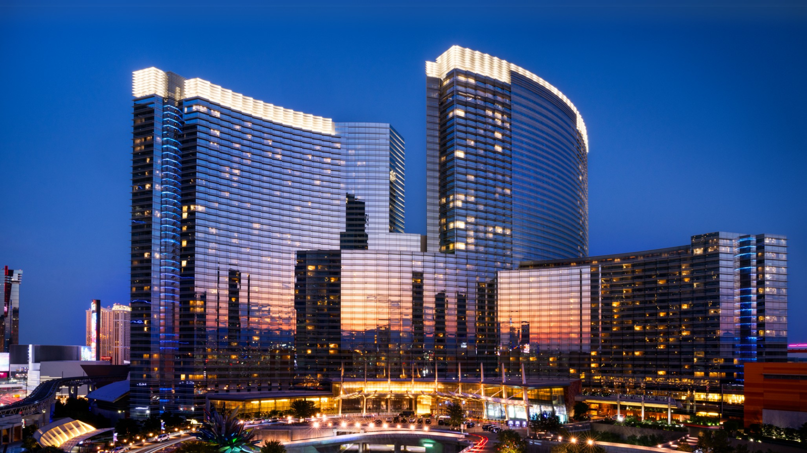 a large building with persony windows with Aria Resort and Casino in the background