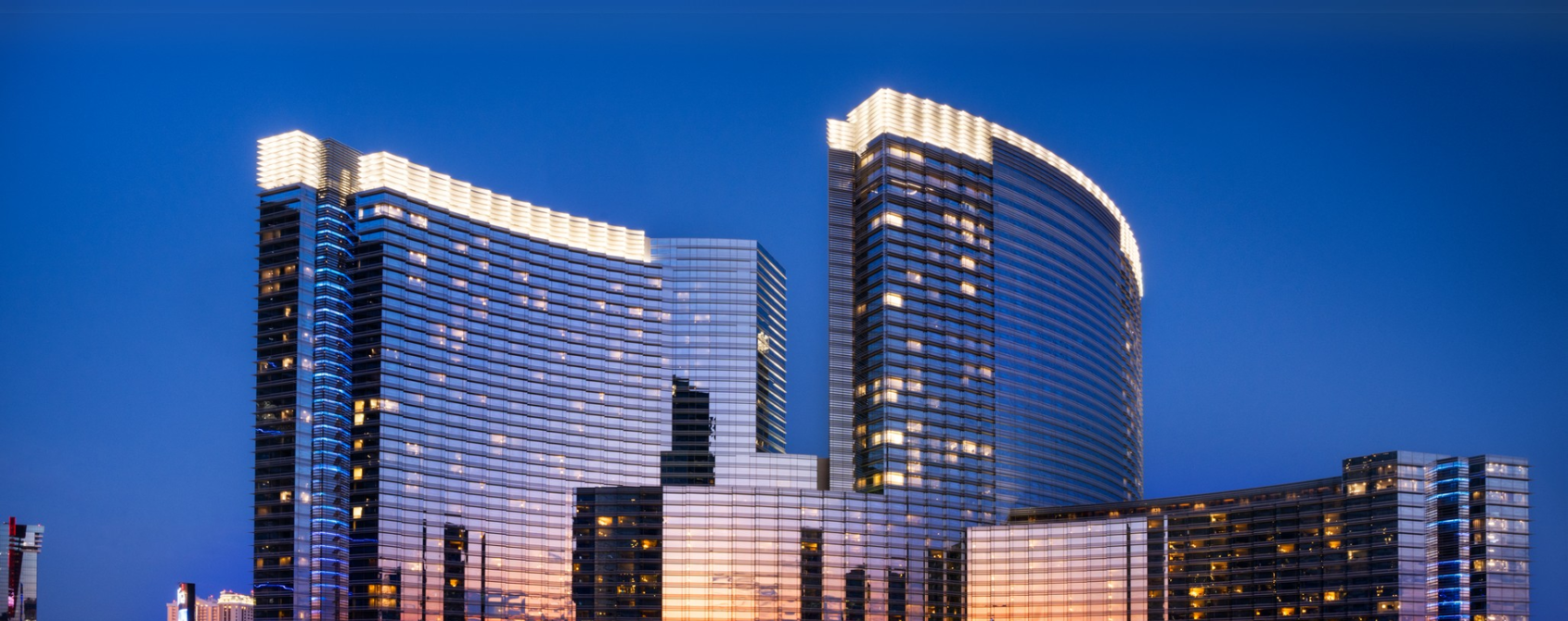 a large building with persony windows with Aria Resort and Casino in the background