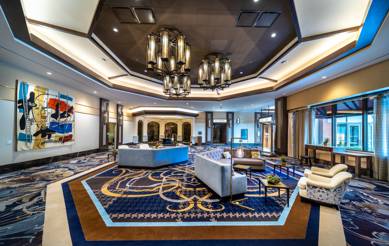 a large room with a large reception desk and chairs