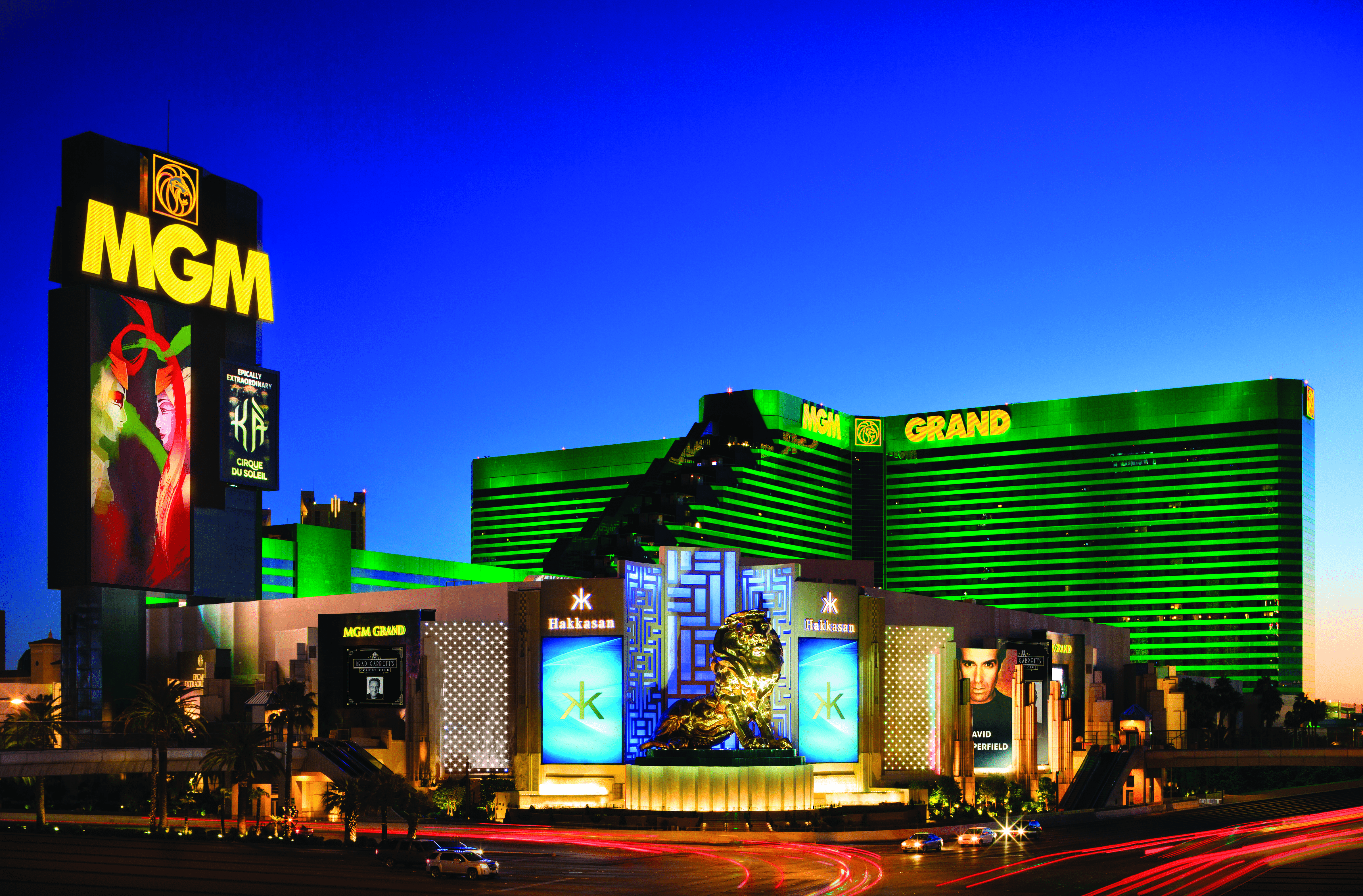 a large building with green lights with MGM Grand Las Vegas in the background