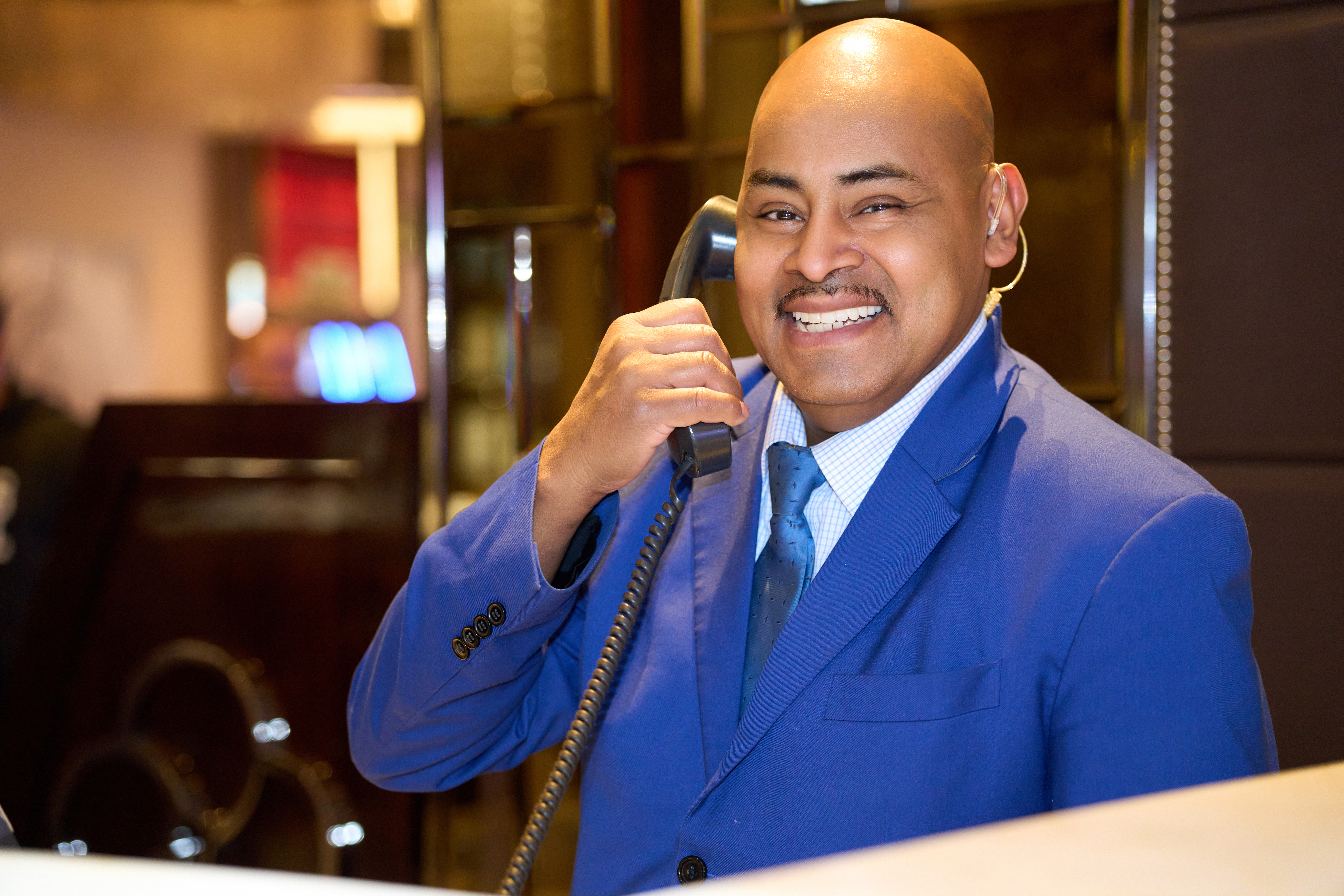 a person in a suit holding a telephone