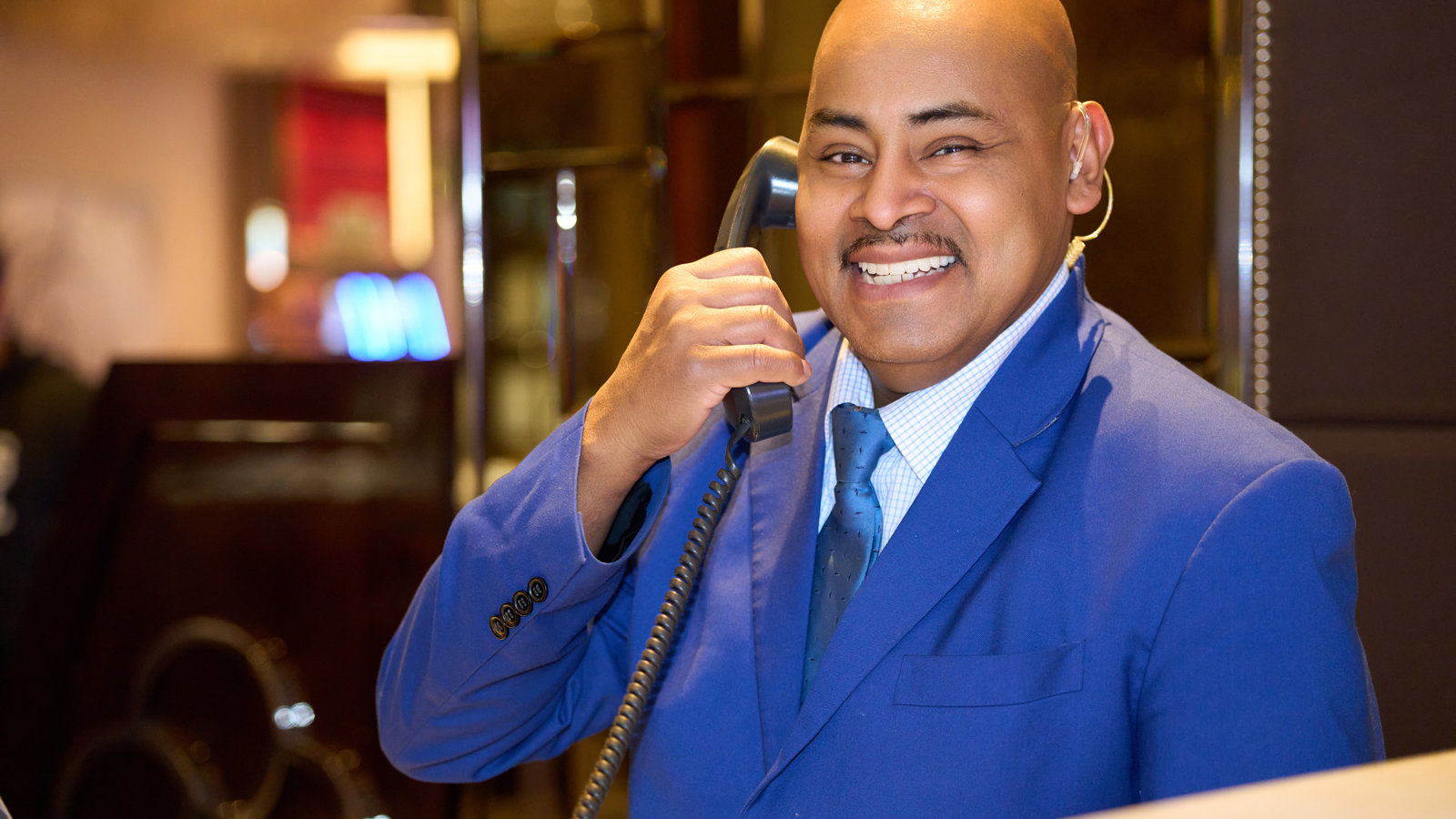 a person in a suit holding a telephone