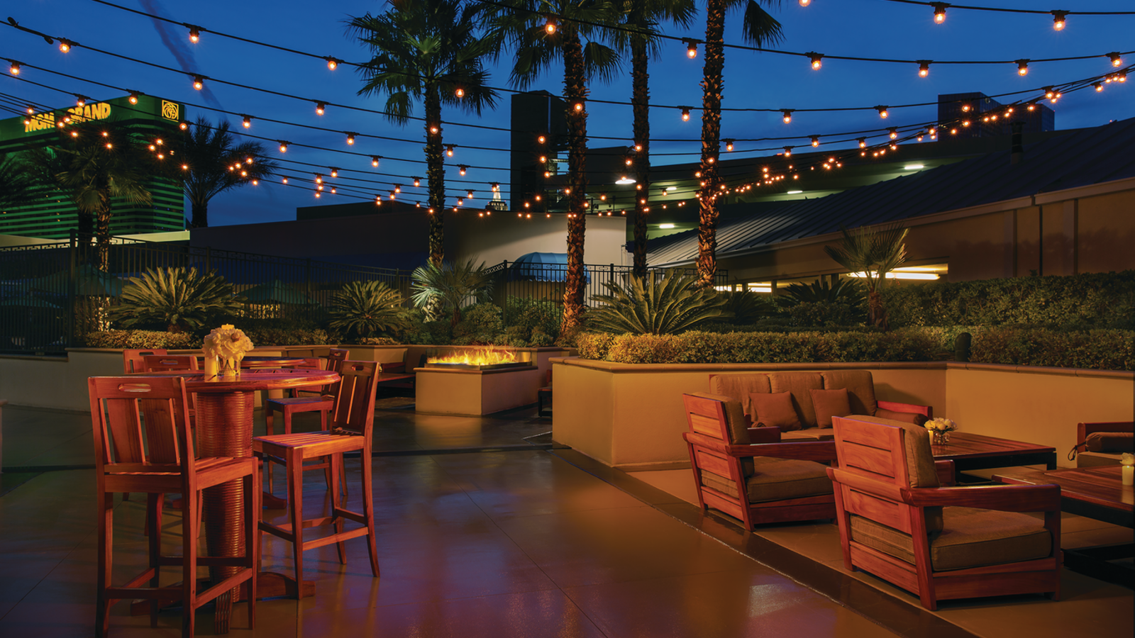 a patio with chairs and tables and lights