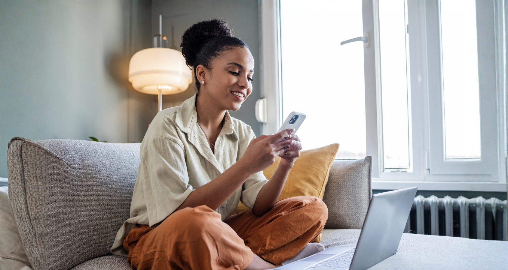 a person sitting on a couch using a phone