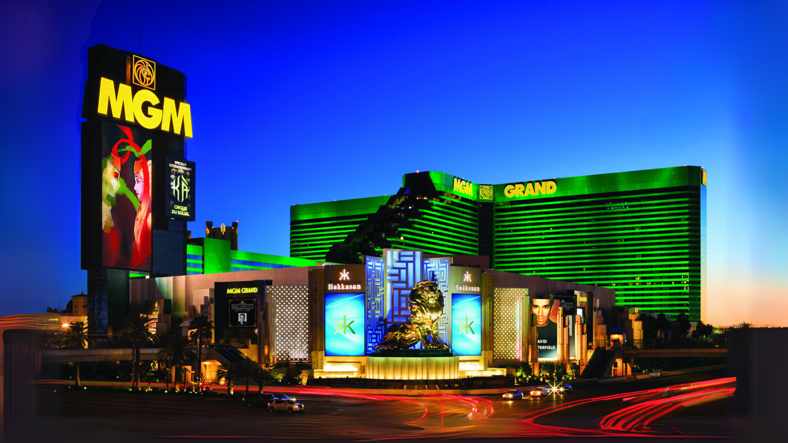 a large building with green lights with MGM Grand Las Vegas in the background