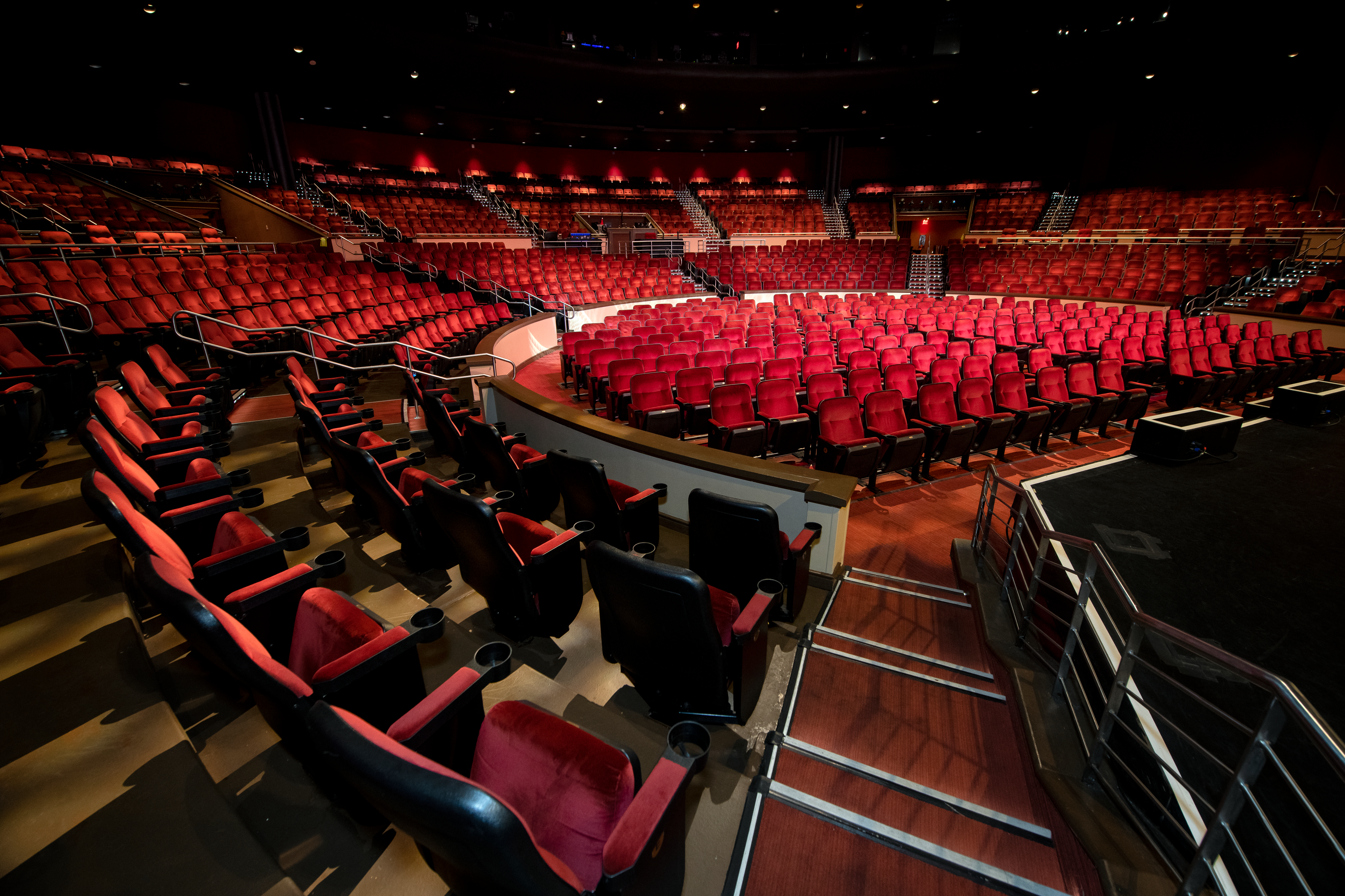 a large theater with red seats