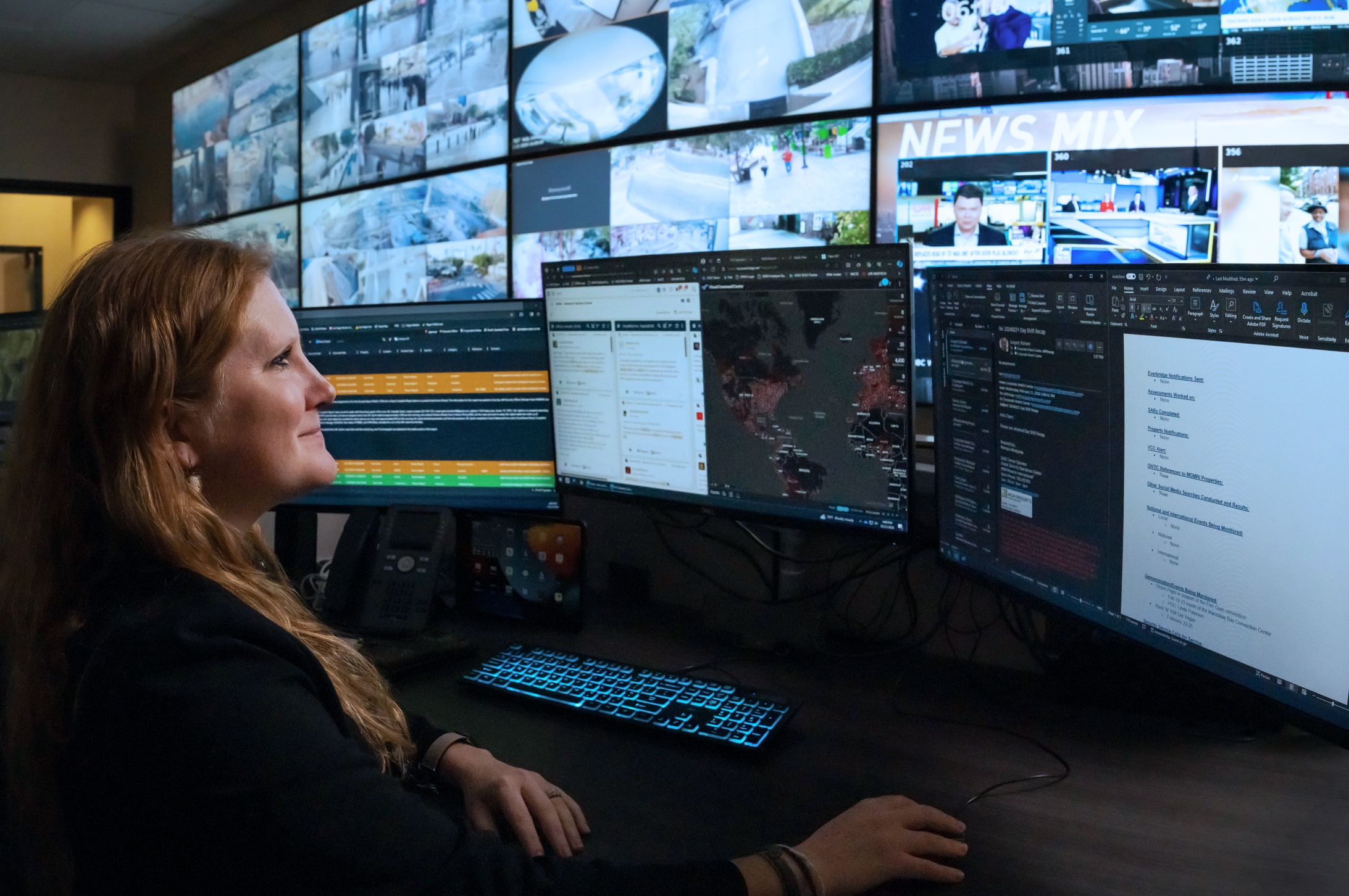 a person sitting in front of multiple screens